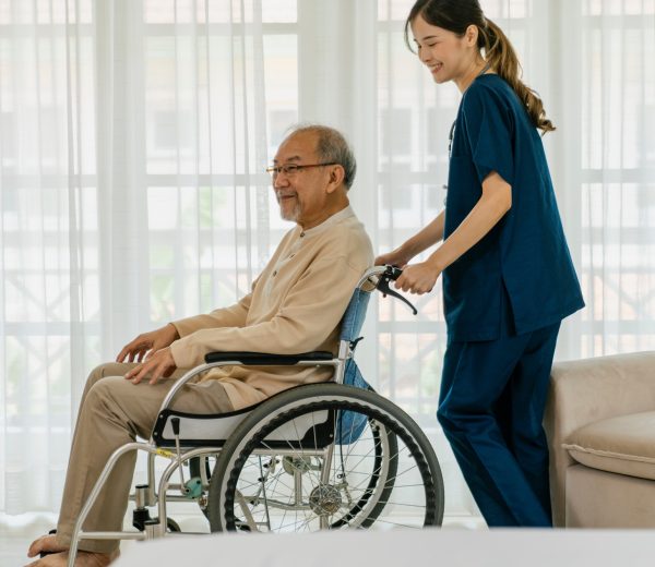 Elderly man with caregiver in nursing home. Elderly man with caregiver in nursing home.